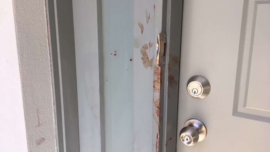 Blood smeared on the front door of a townhouse