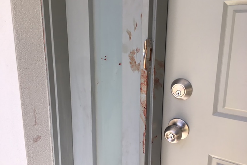 Blood smeared on the front door of a townhouse