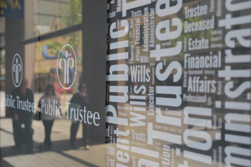A reflection of people walking in a window with the words Public Trustee written on it.