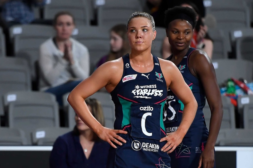 A Melbourne Vixens Super Netball player stands with her hands on her hips after a draw against West Coast Fever.