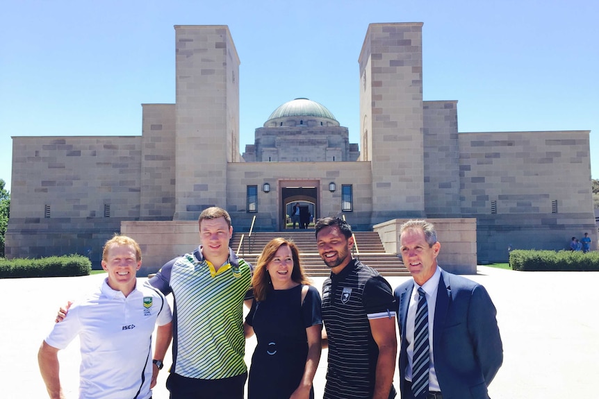 ACT Sports Minister Yvette Berry stand with rugby league players and officials outside the Australian War Memorial.