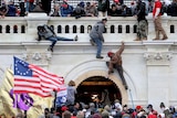 People scale a wall at Capitol Hill in Washington DC