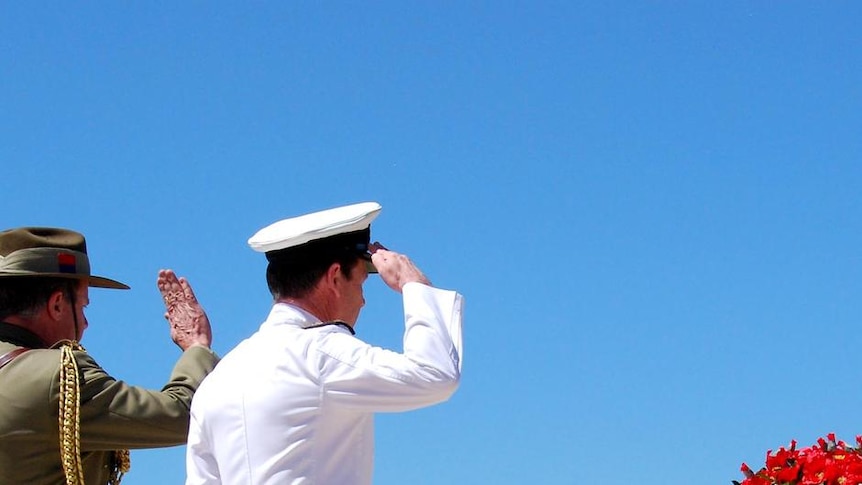 Members of the Armed Services salute the Stone of Remembrance outside the Australian War Memorial