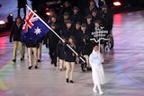Joany Badenhorst carries the flag for Australia at the 2018 Winter Paralympics opening ceremony.