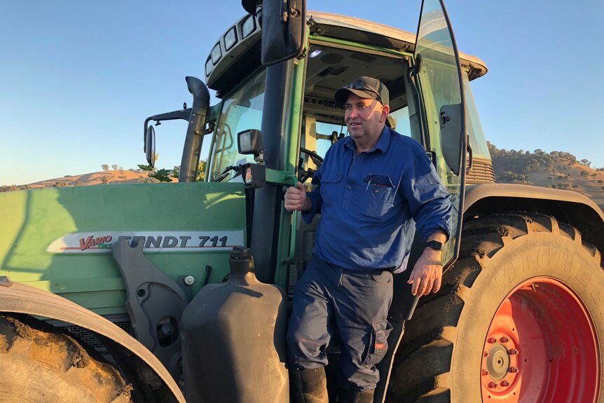 Dairy farmer Stephen Coulston standing at a tractor