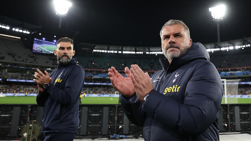 Ange Postecoglou and Mile Jedinak look up at the crowd at the MCG