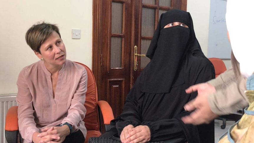 A woman wearing a burka speaks to labor senator jenny mcallister
