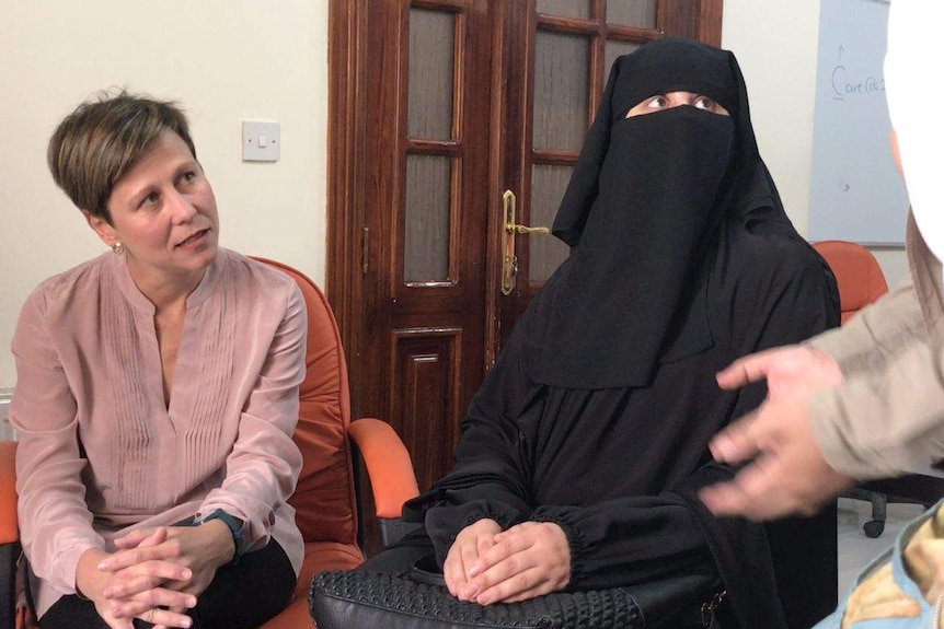 A woman wearing a burka speaks to labor senator jenny mcallister