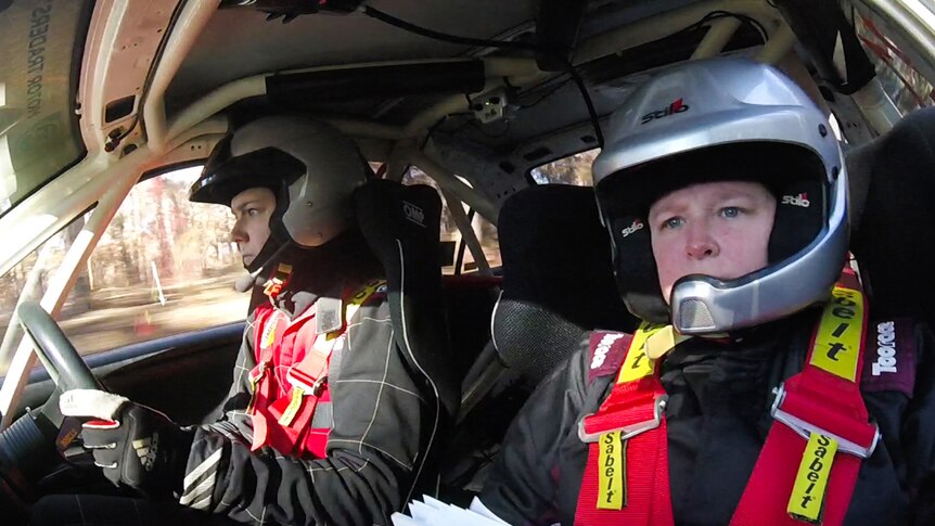 Female driver and co-driver in their car competing in a rally event