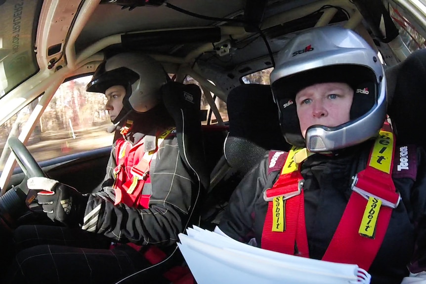 Female driver and co-driver in their car competing in a rally event