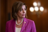 Nancy Pelosi in a pink jacket
