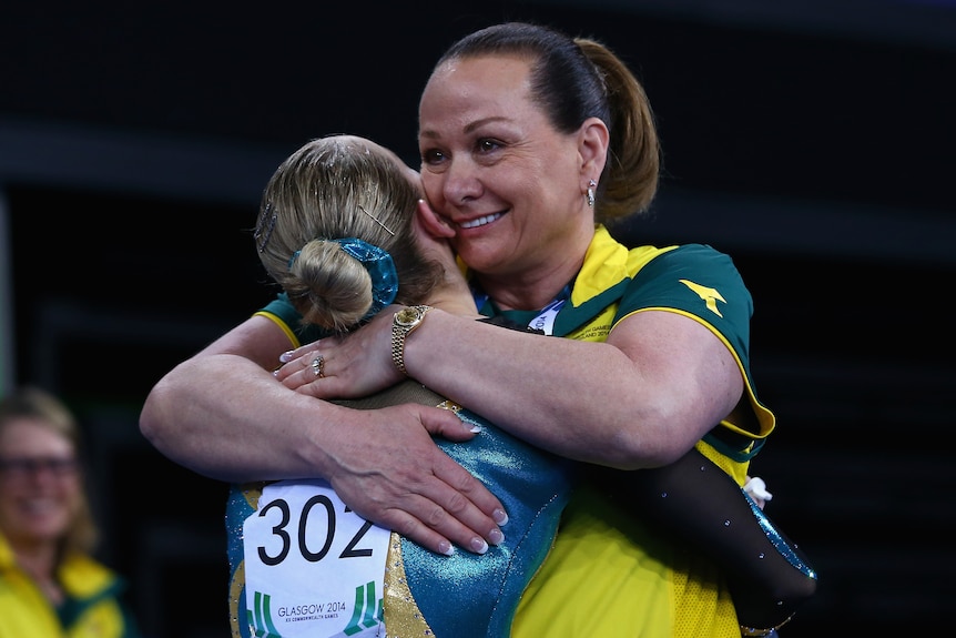 Peggy Liddick smiles as she gives Larrissa Miller a hug