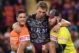 Tom Trbojevic carried from the field injured by Manly trainers