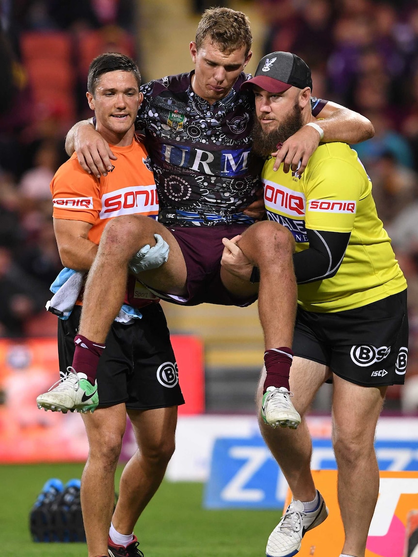 Tom Trbojevic is carried from the field by Sea Eagles trainers after being injured against the Broncos.