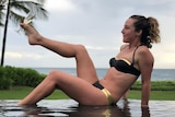 Rebecca Andrews sipping champagne in Hawaii while a hurricane was coming
