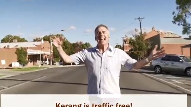 Man singing while standing on road