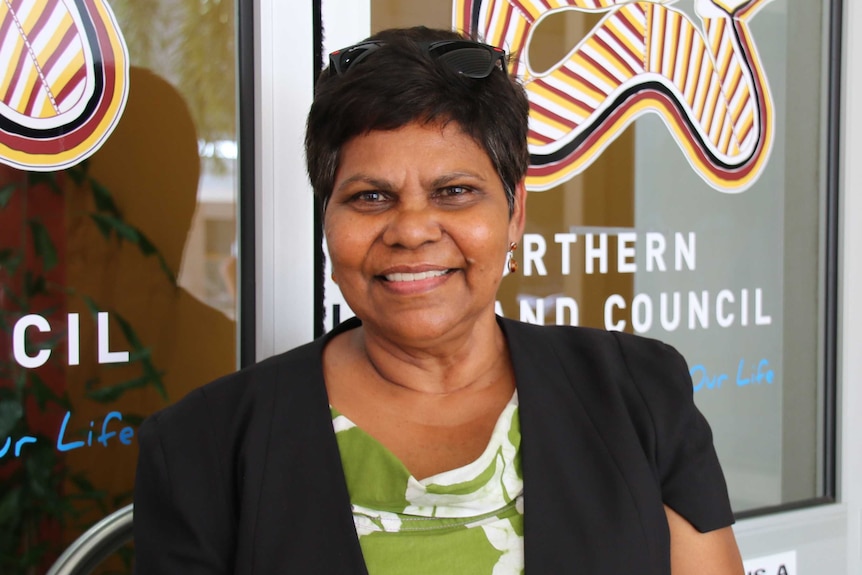 A woman smiles into the camera.