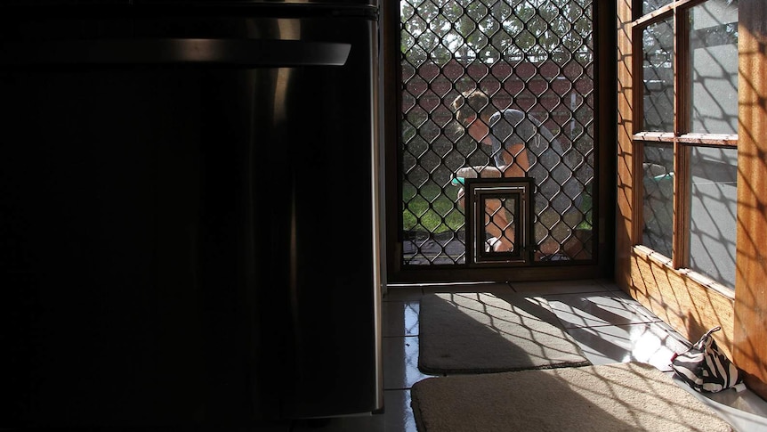 A photo of marine science researcher Annemarie Fearing through a kitchen door, with some nice afternoon sunlight.