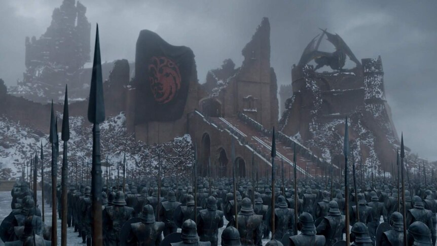 Targaryen banner unfurled on what's left of King's Landing as lines of soldiers watch on.
