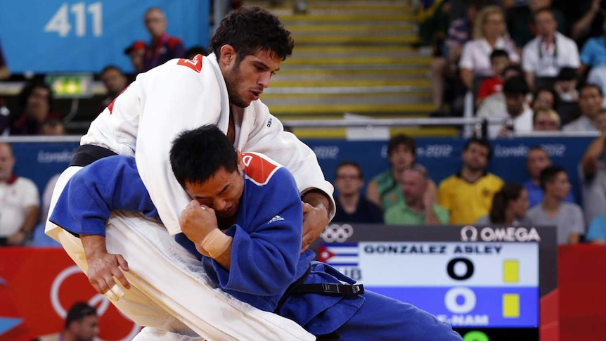 South Korea's Song Dae-Nam fights with Cuba's Asley Gonzalez in men's -90kg final judo match