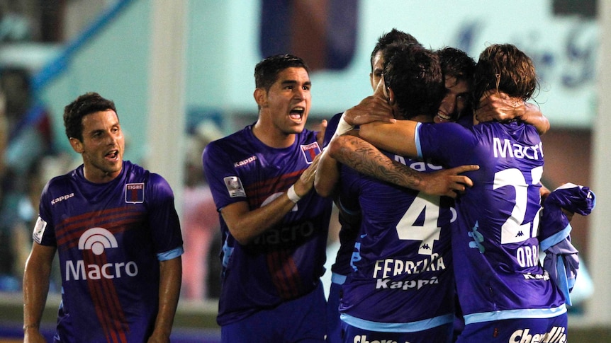 Tigres players hugging after a goal