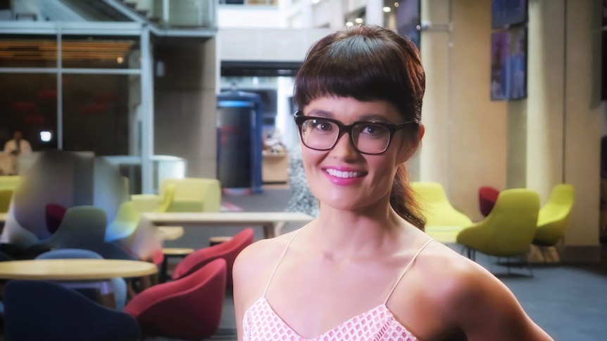 A headshot of Yumi Stynes, wearing a singlet and glasses. 