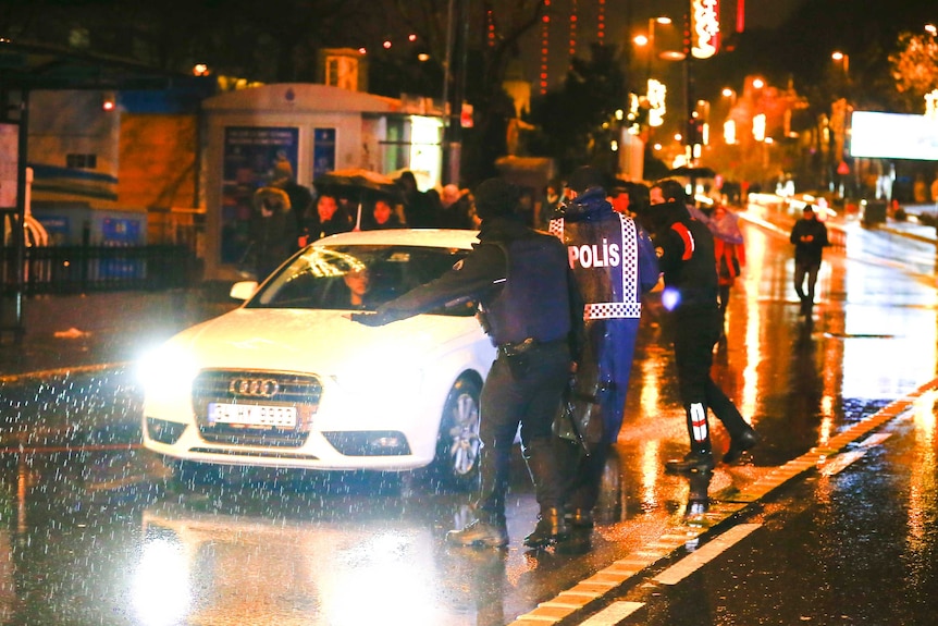 Police secure the area around an Istanbul nightclub after a shooting there.