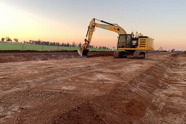 A digger working on constructing a rail track