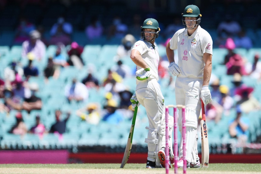 Australia batsmen Tim Paine (left) and Cameron Green talk near the pitch between overs during a Test at the SCG.