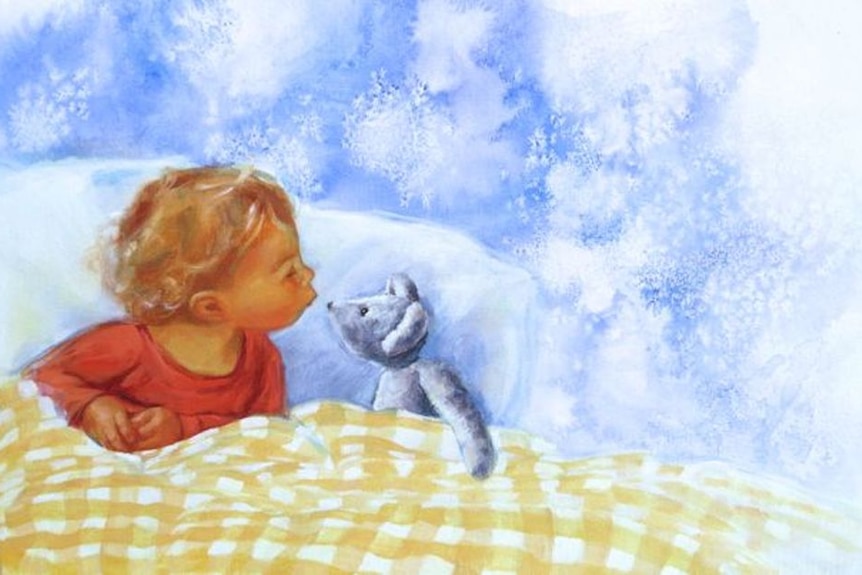 Toddler kissing a teddy bear in bed