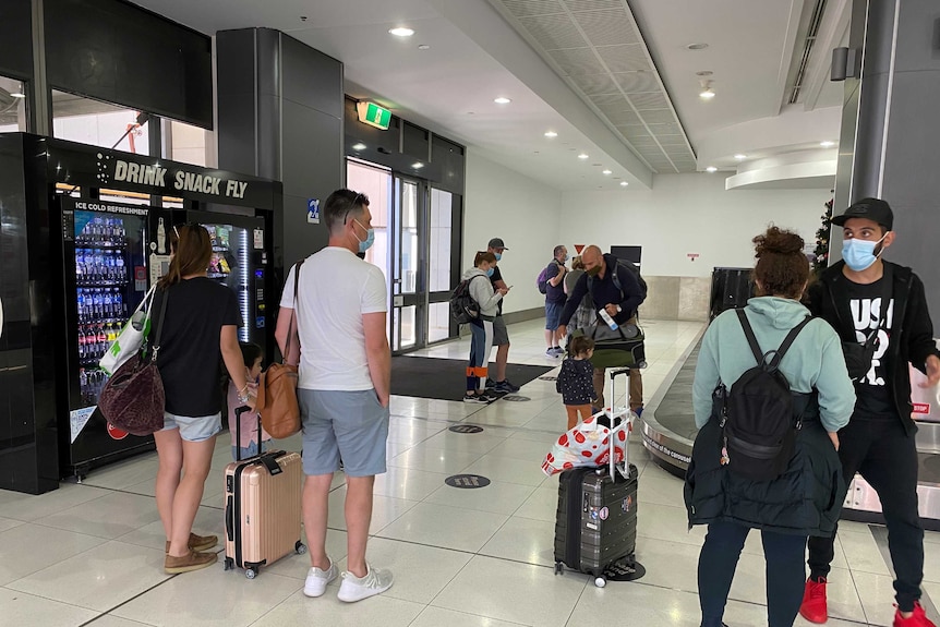 People standing around at an airport.