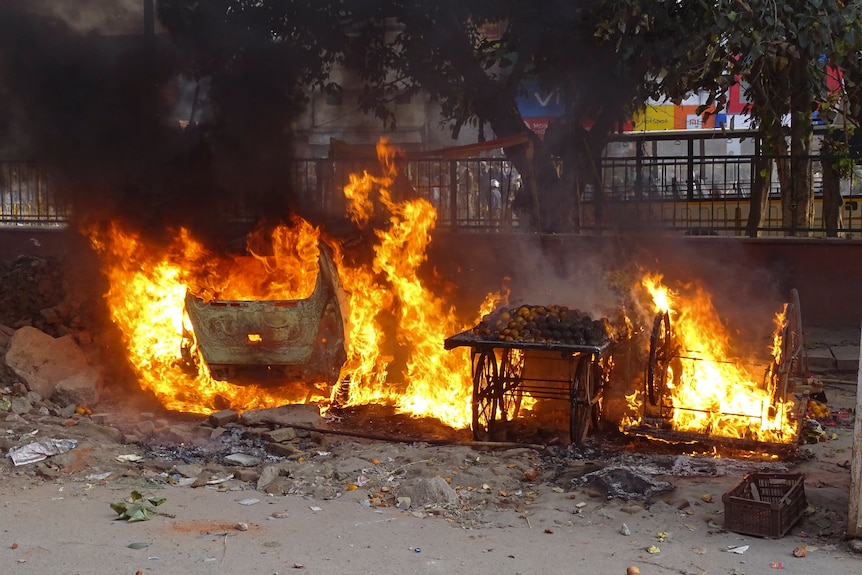 Push carts on the street go up in flames.