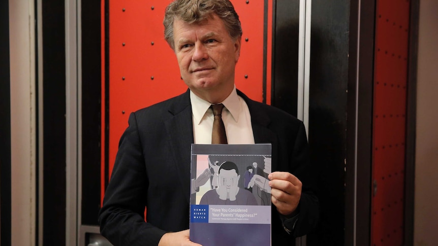 Human Rights Watch's Boris Dittrich poses with the report.