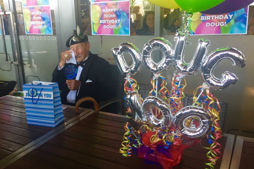 Doug Cunningham celebrates his 100th birthday, surrounded by 100 women, fulfilling a wartime promise.