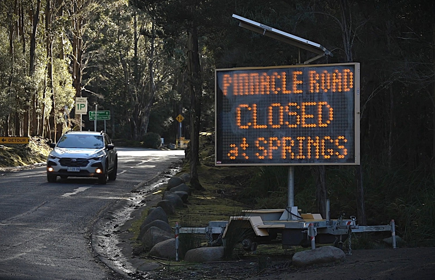 Sign advising summit road closure.