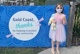 A six-year-old girl at a vaccine clinic with a teddy.