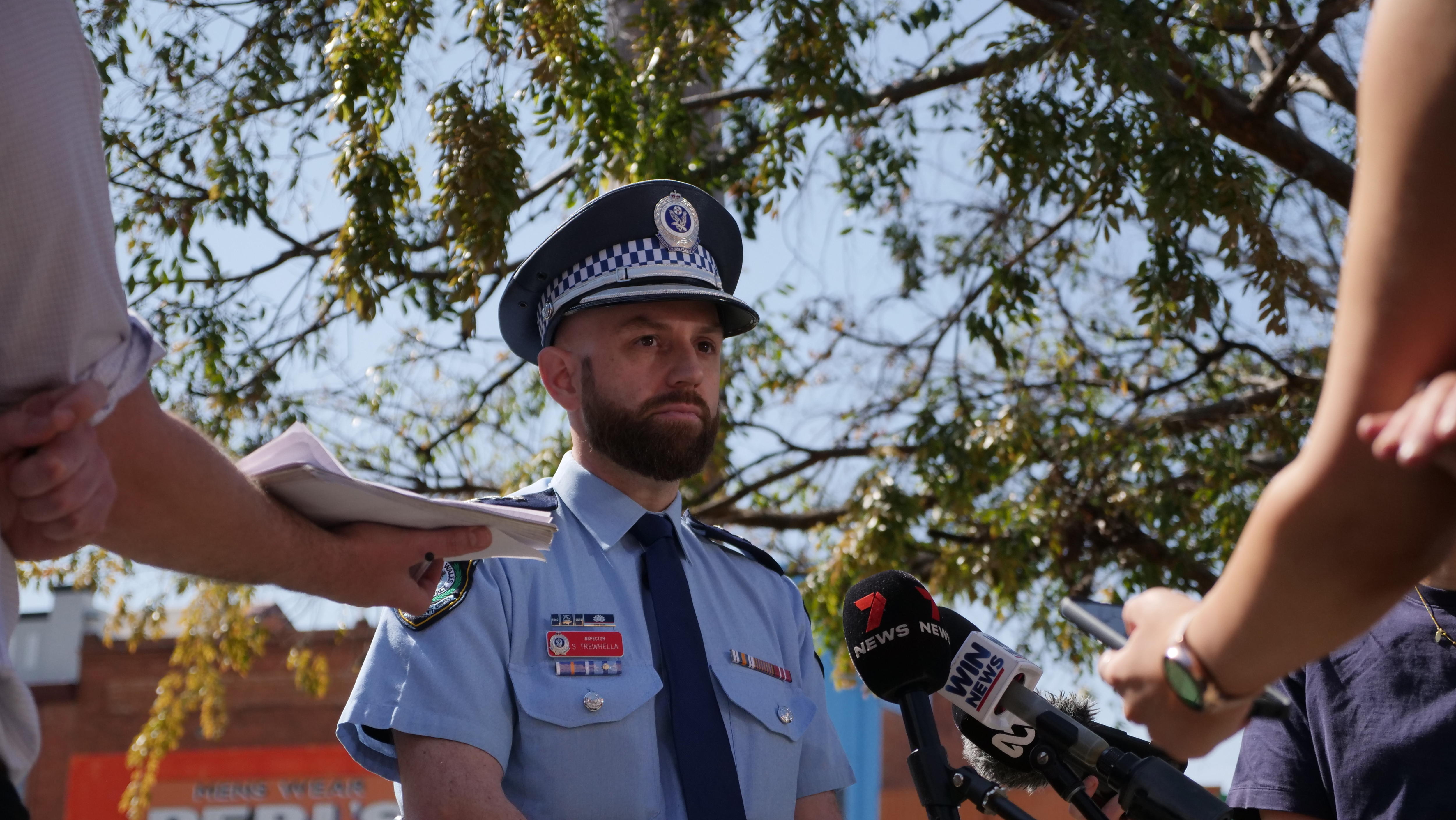 A policeman addresses media