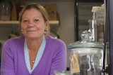 Sharon Sweeney next to Coffee Box menu