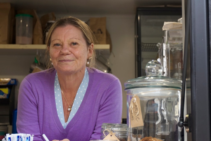Sharon Sweeney next to Coffee Box menu