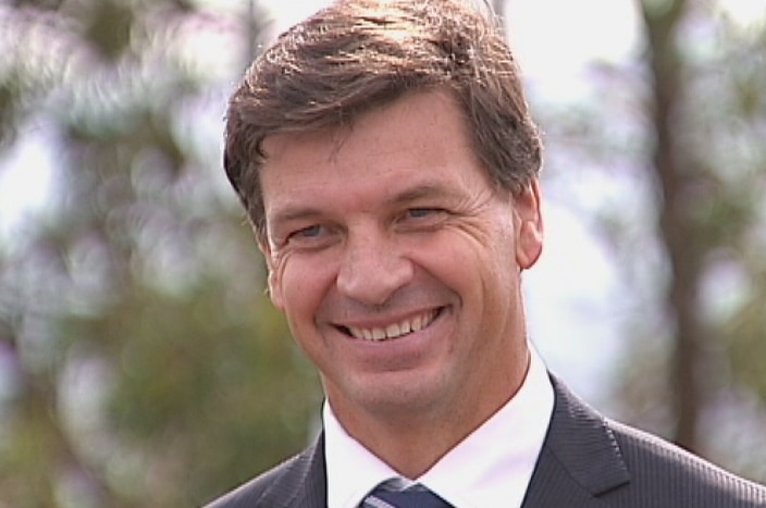 A smiling, middle-aged man in a suit and tie.