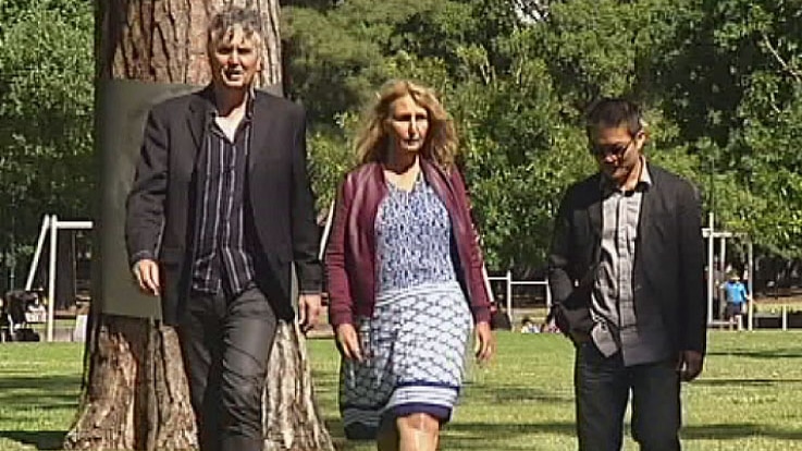 Martin Elpans, Wendy Robertson, Man Nguyen walking in a park.