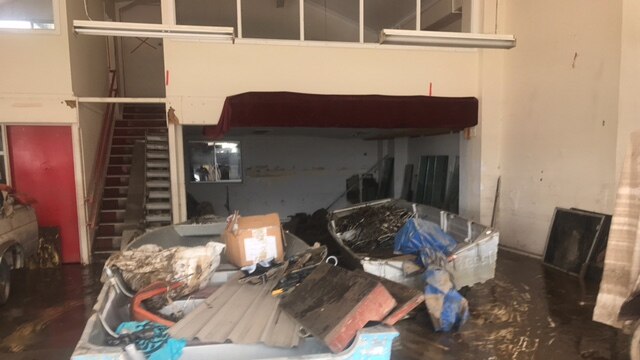 A boat sits inside a business in Murwillumbah where clean-up has begun.