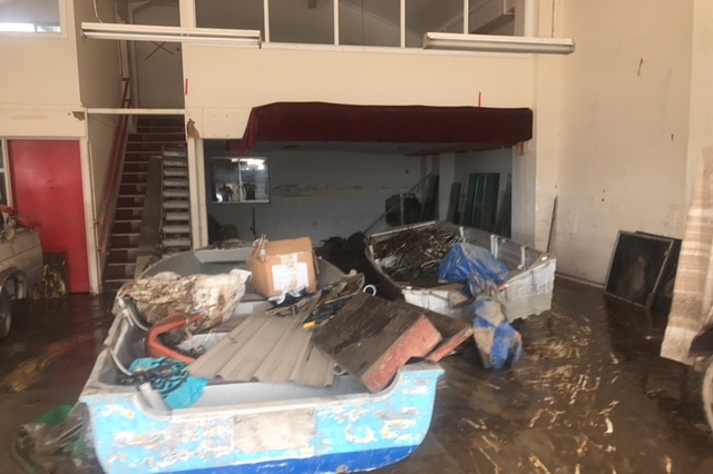 A boat sits inside a business in Murwillumbah where clean-up has begun.