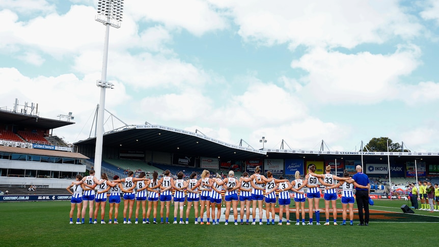 North Melbourne players lined up for the national anthem before a game