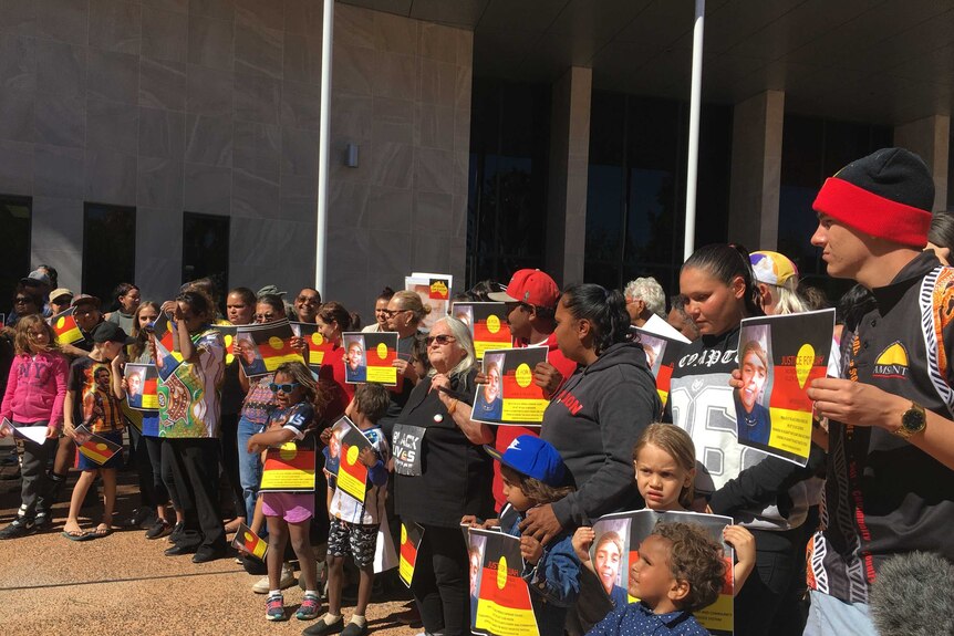 A group of protestors standing outside the Alice Springs Supreme Court.