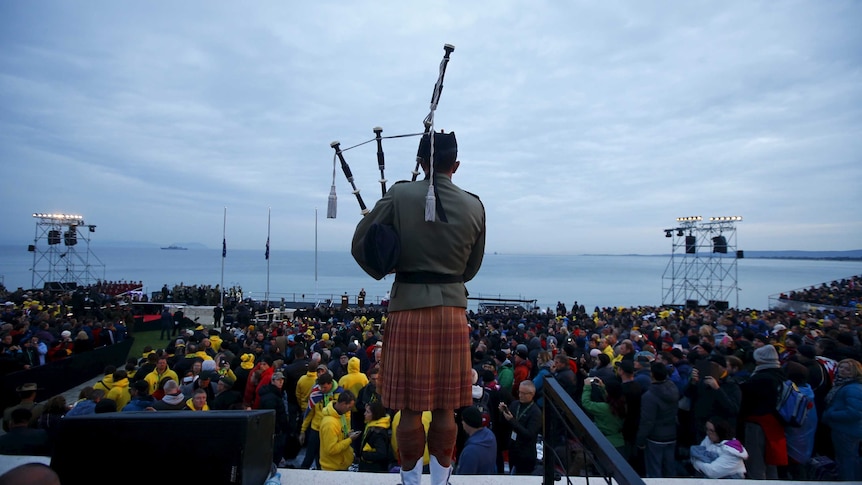 Bagpiper performs in front of Anzac Cove