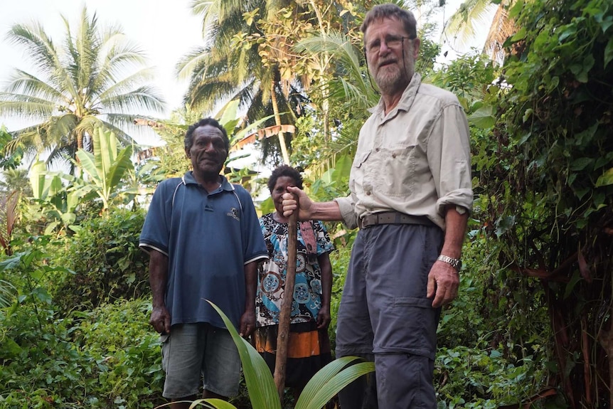 Bryant Allen and Bansis Morris plant a coconut palm