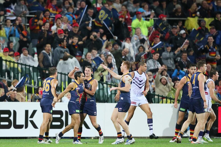 Eddie Betts (2nd L) is congratulated by Crows team-mates after his goal against Fremantle.