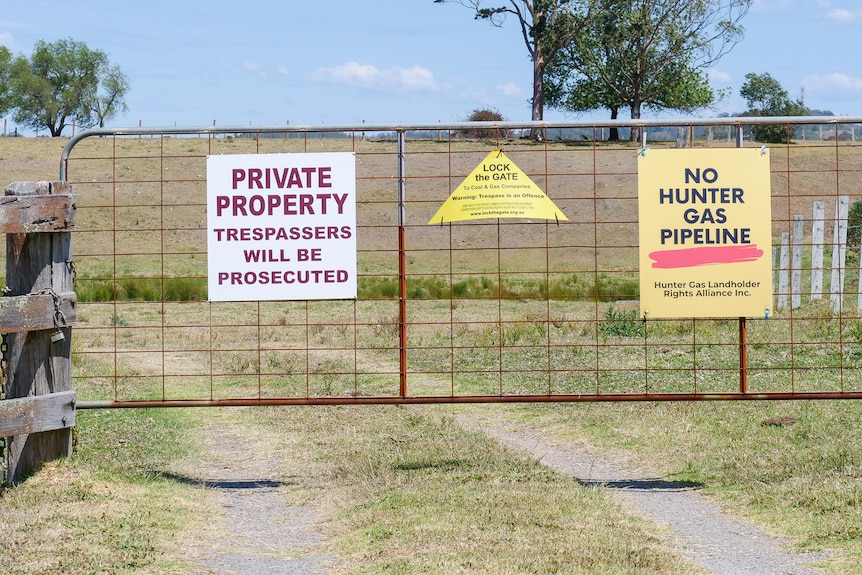 A gate with signs reading 'Private Property' and 'No Hunter Gas Pipeline' on farm land near Maitland, October 2023.