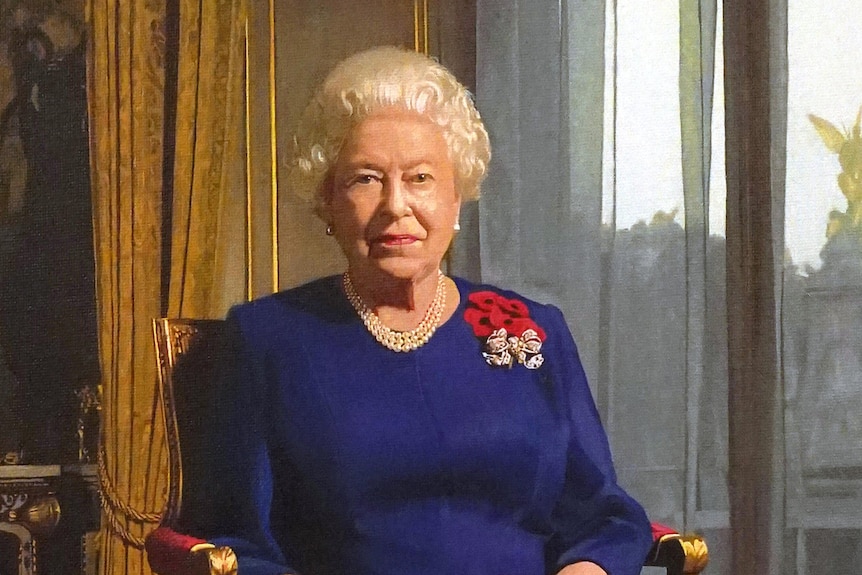 A full length portrait of Queen Elizabeth II wearing a spray of five poppies.
